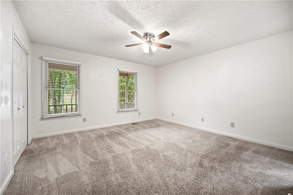 2009 Ben Higgins Road Dahlonega, GA 30533 - Photo 11 of 25 an empty room with windows and fan