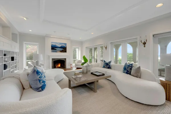 a dining room with furniture a chandelier and wooden floor
