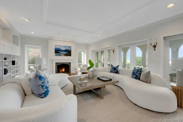 a dining room with furniture a chandelier and wooden floor