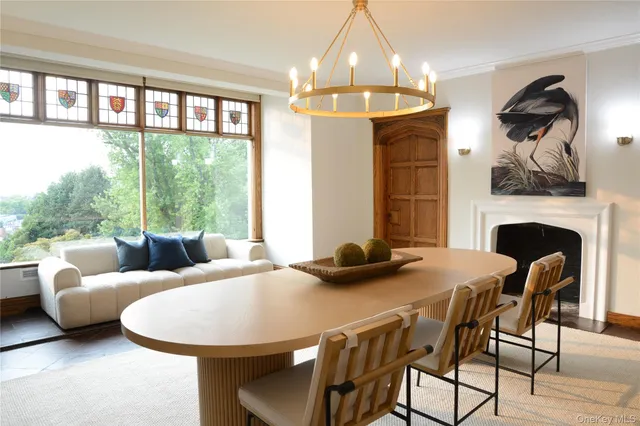 a kitchen with a stove a sink a dining table and chairs