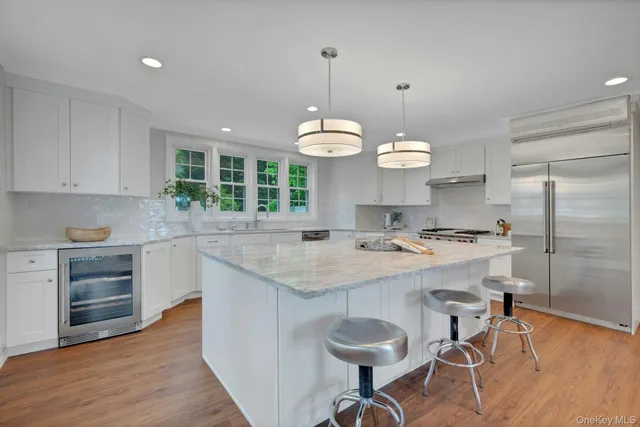 a bedroom with two beds and a chandelier
