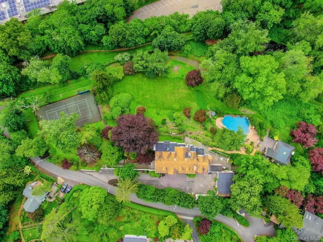 an aerial view of a house with a garden and yard