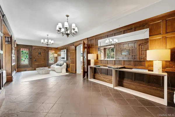 a living room with furniture and a chandelier