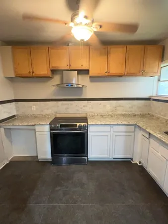 a kitchen with a cabinets and white appliances