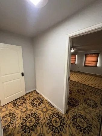 a view of a house with a car parked in garage