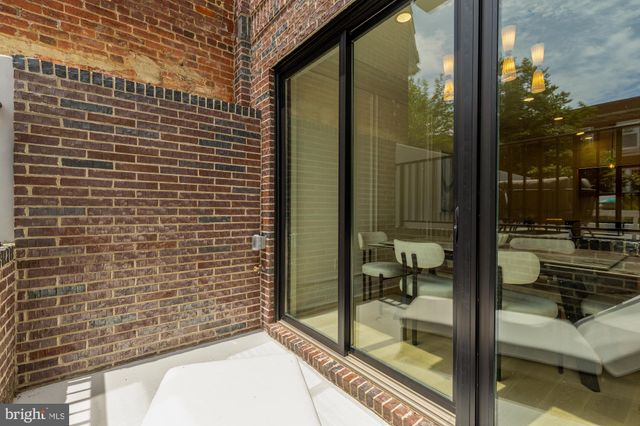 a kitchen with kitchen island a stove a refrigerator and a dining table with wooden floor