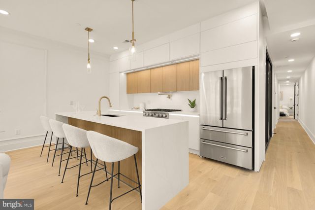 a kitchen with a table chairs sink and cabinets