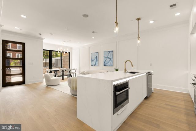 a kitchen with stainless steel appliances granite countertop a sink and cabinets