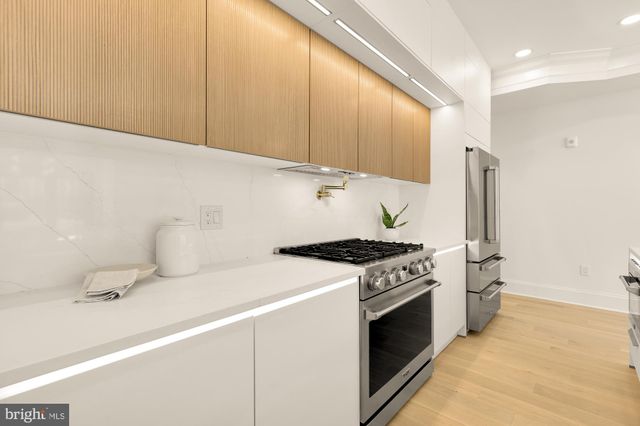a kitchen with a stove and a sink