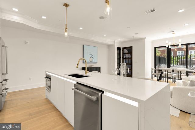 a spacious bedroom with a bed and a potted plant