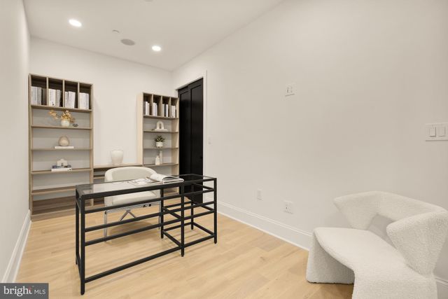 a view of a hallway with furniture and a large window