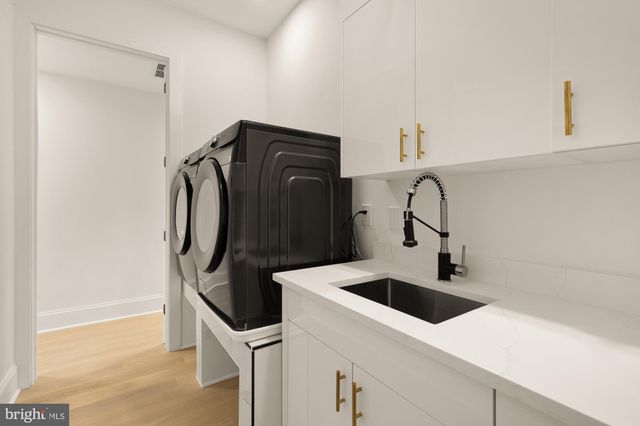 a bathroom with a double vanity sink a toilet and a shower