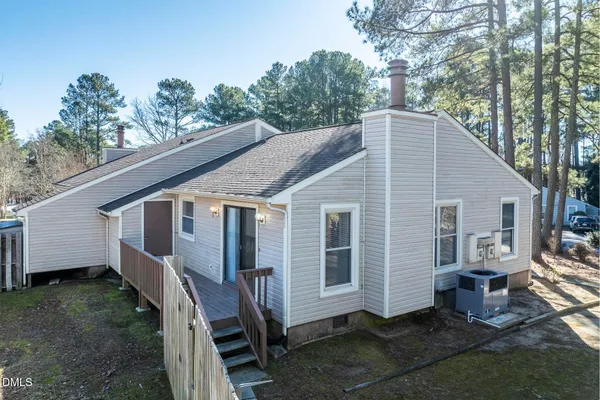 a view of a house with a yard and wooden fence