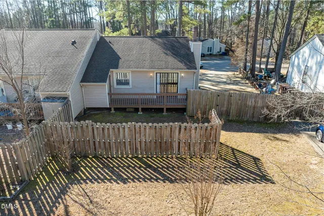 a view of a house with wooden fence