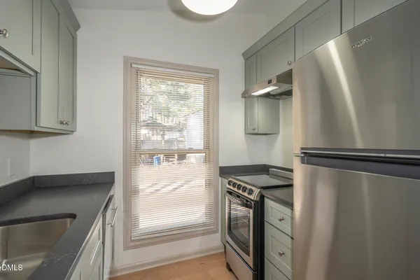 a kitchen with a refrigerator and a sink
