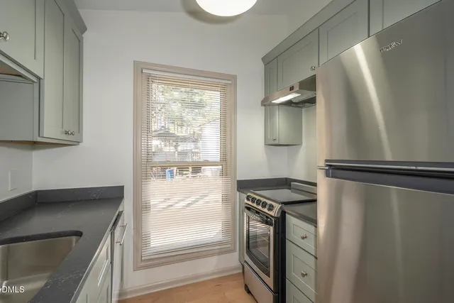 a kitchen with a refrigerator and a sink