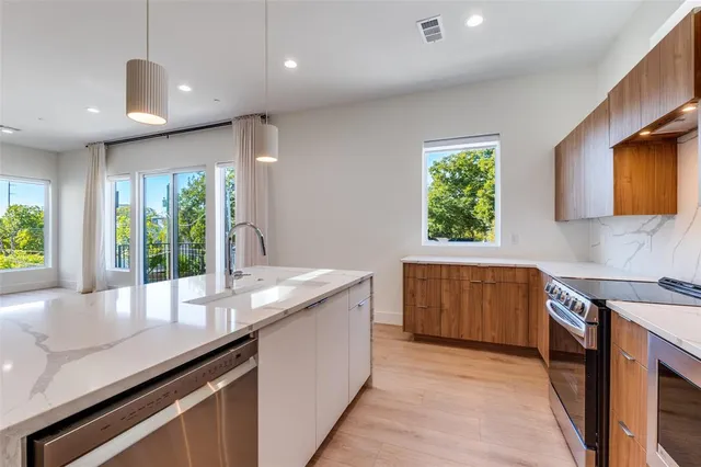 a kitchen with a sink and large window