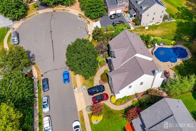 an aerial view of a house with a yard and outdoor seating