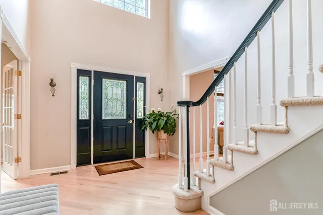 a living room with furniture a large window and a fireplace
