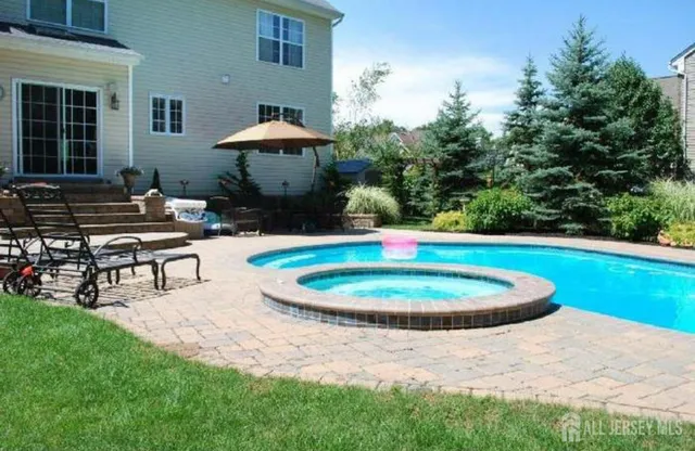 a swimming pool with outdoor seating yard and outdoor seating