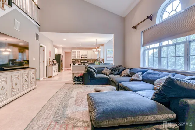 a dining room with furniture a window and a chandelier