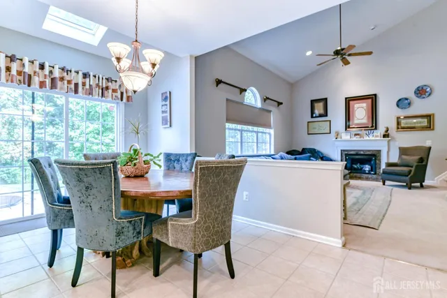 a kitchen with kitchen island granite countertop wooden cabinets dining table and chairs