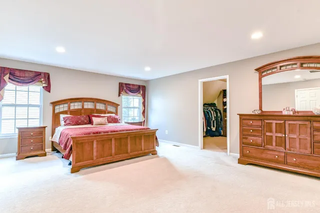 a bedroom with a bed chair and a window