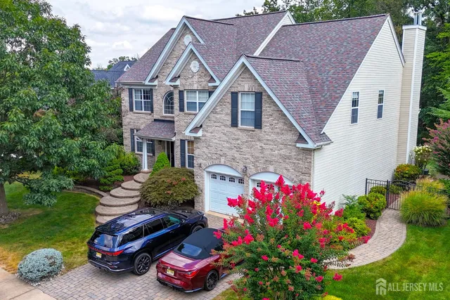 a front view of a house with a yard and street