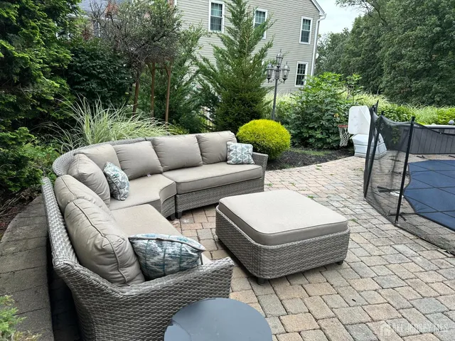 a view of a patio with couches and a table and chairs