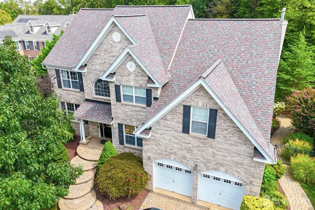 a aerial view of a house next to a yard