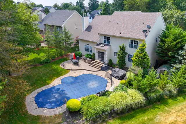 an aerial view of a house with garden space and street view