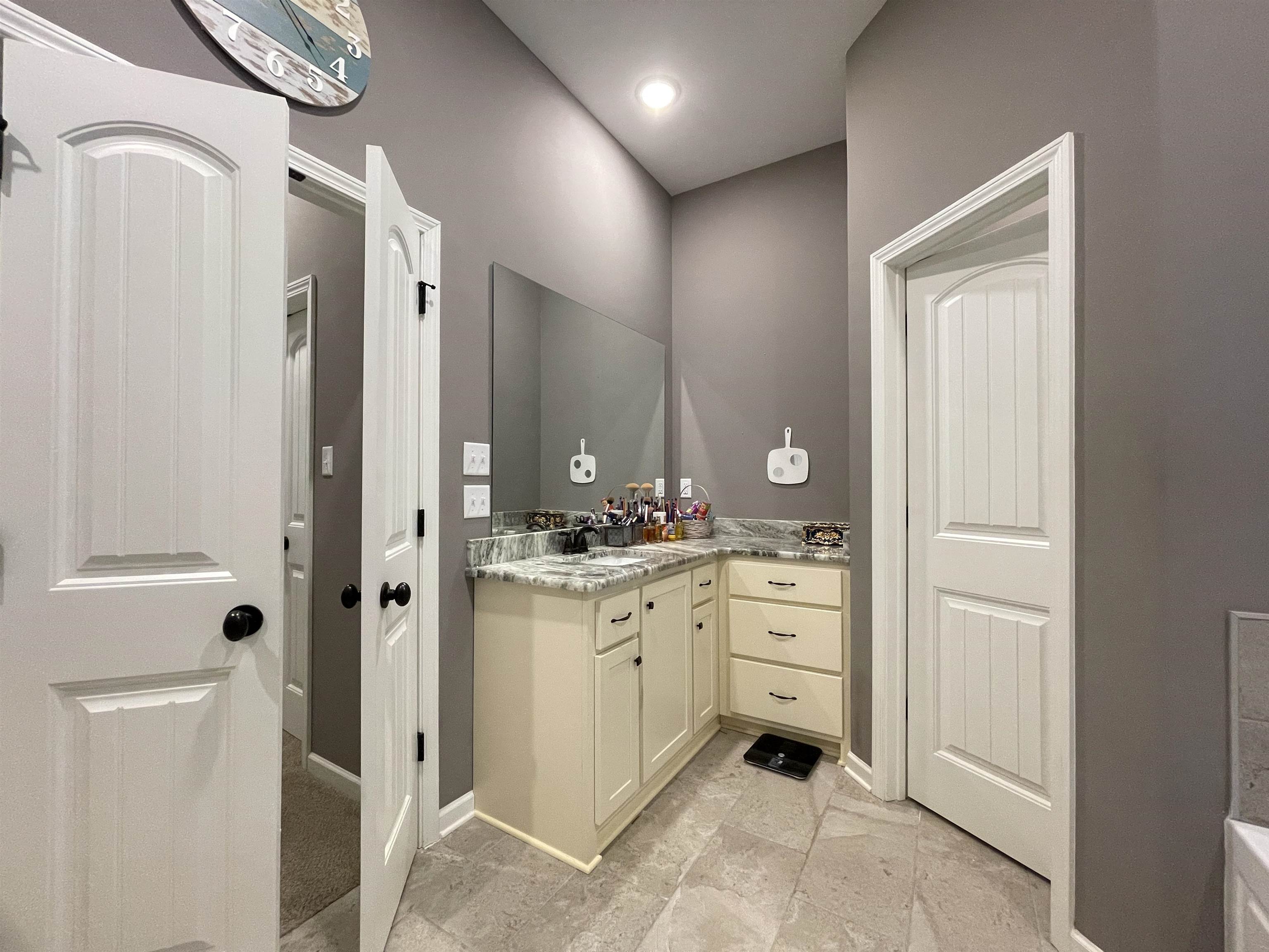 16691 Highway 59 Drummonds, TN 38023 - Photo 18 of 40 a spacious bathroom with a granite countertop sink a mirror and a shower