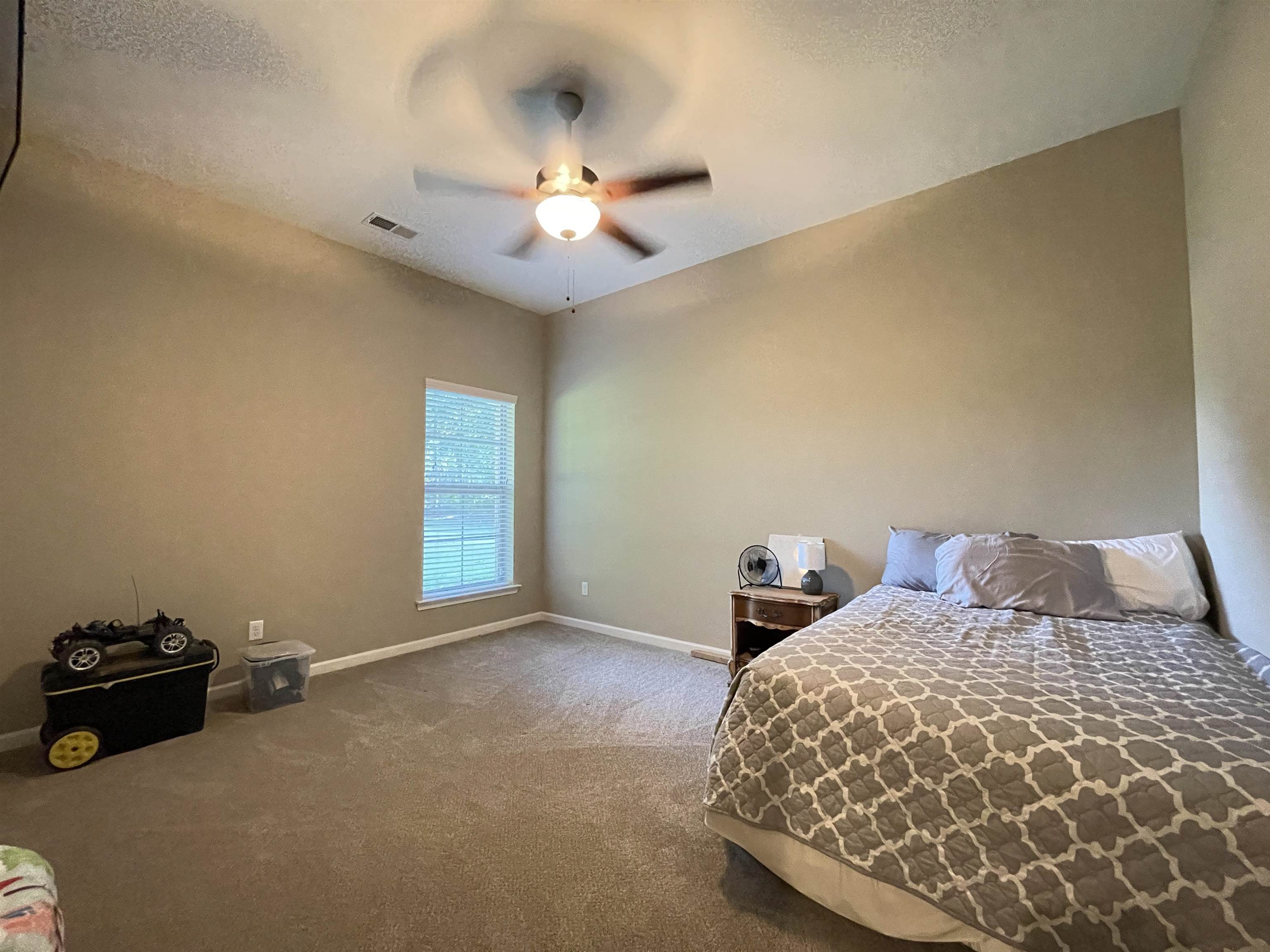 16691 Highway 59 Drummonds, TN 38023 - Photo 22 of 40 a bedroom with a bed and a chandelier