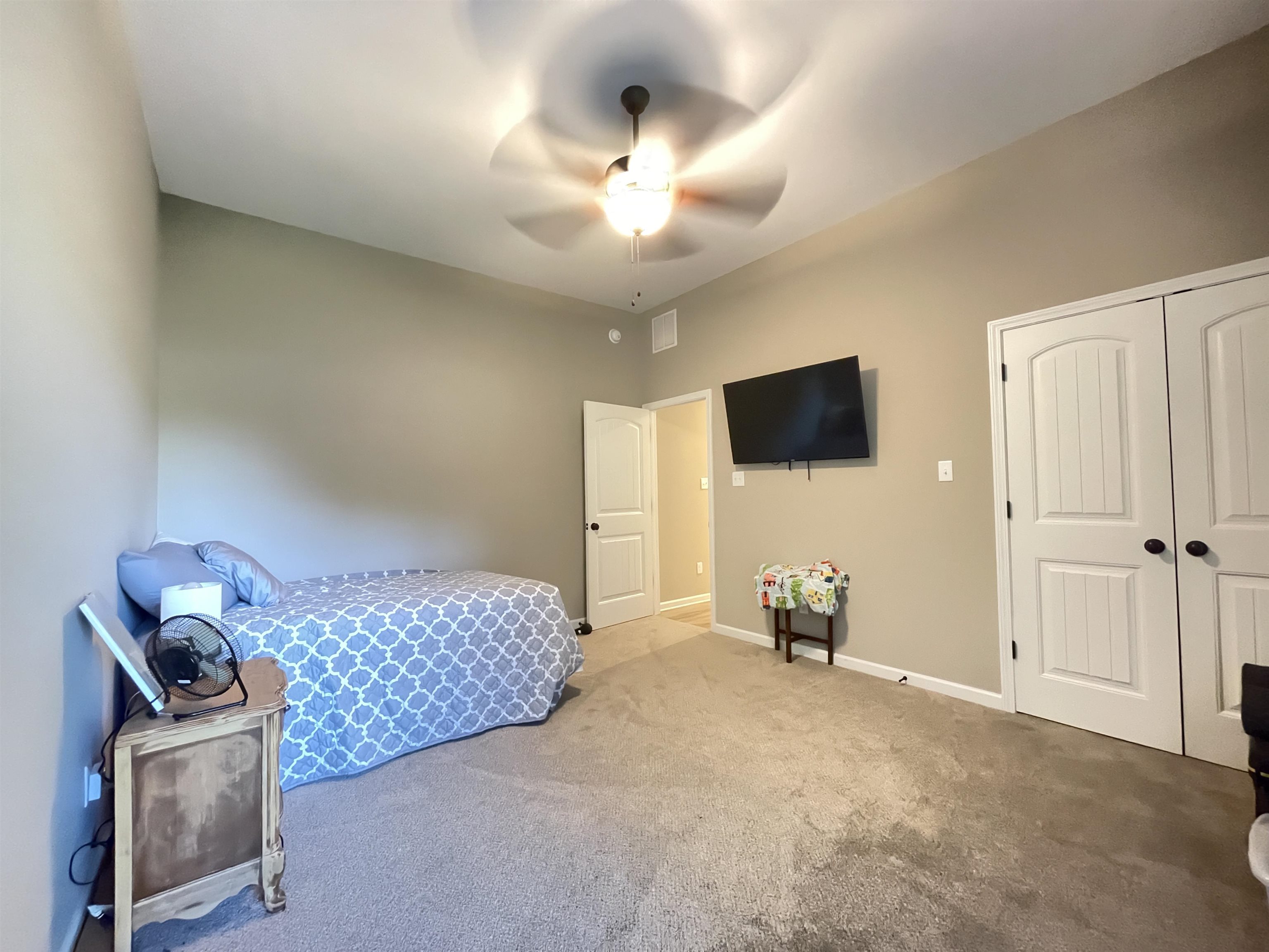 16691 Highway 59 Drummonds, TN 38023 - Photo 23 of 40 a bedroom with furniture and a flat screen tv