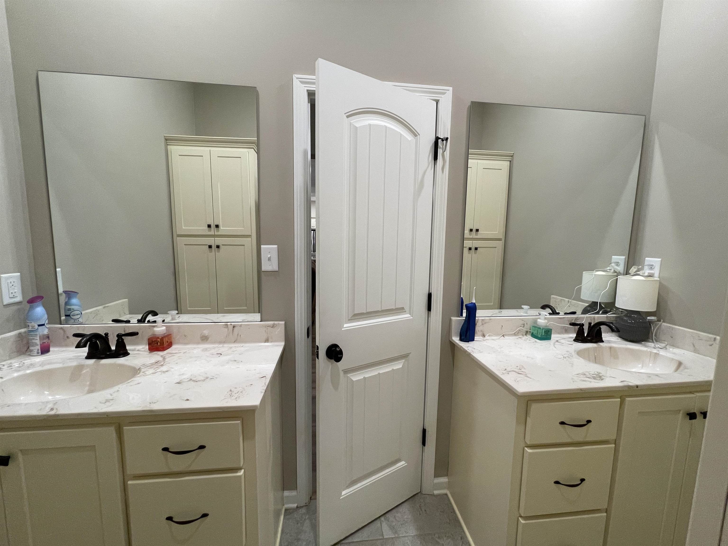 16691 Highway 59 Drummonds, TN 38023 - Photo 27 of 40 a bathroom with a sink double vanity and a mirror