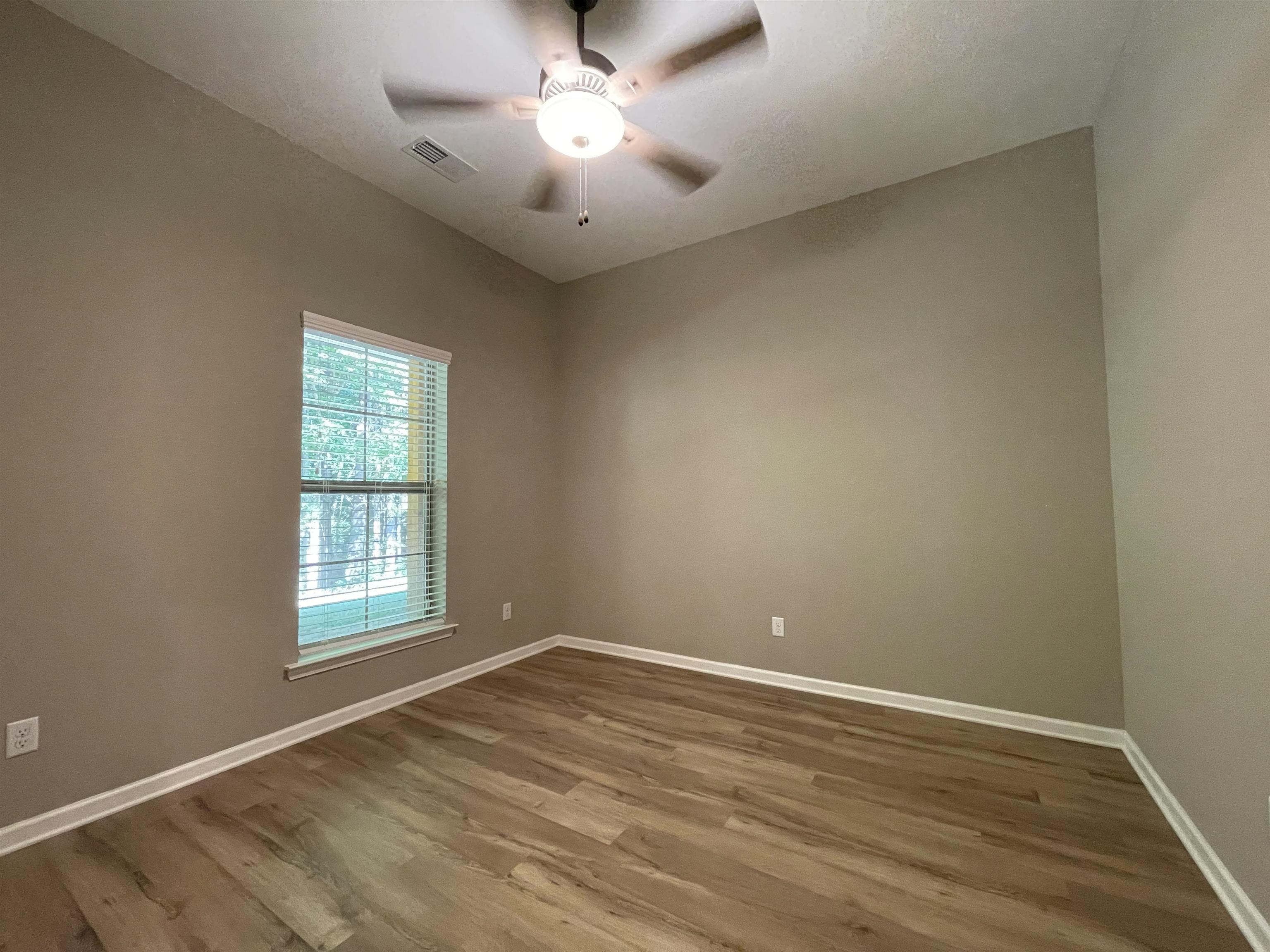 16691 Highway 59 Drummonds, TN 38023 - Photo 28 of 40 an empty room with wooden floor and windows