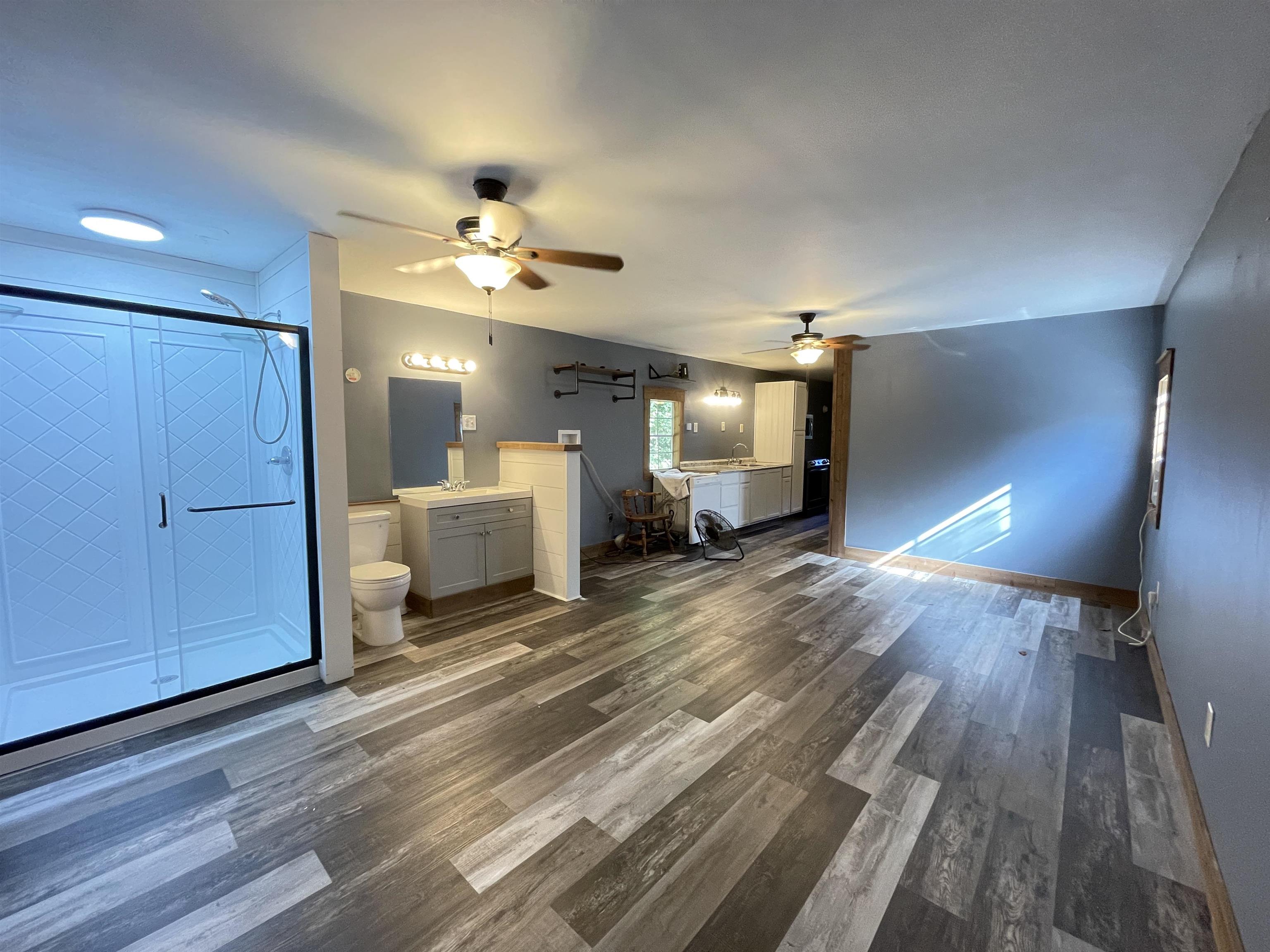 16691 Highway 59 Drummonds, TN 38023 - Photo 33 of 40 a spacious bedroom with a bed and a chandelier