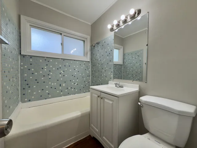 a bathroom with a sink a toilet and bathtub