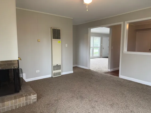 a view of a livingroom with an empty space and a fireplace