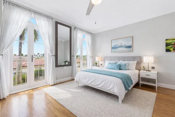 a spacious bedroom with a large bed and a large window