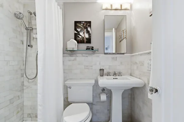 a bathroom with a sink mirror and toilet