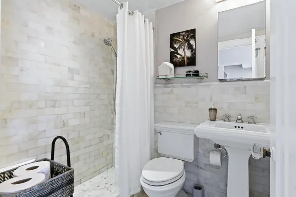 a bathroom with a sink toilet and mirror
