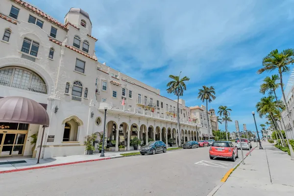 a front view of building with cars parked