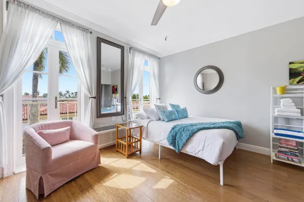 a bedroom with a bed couch and a window