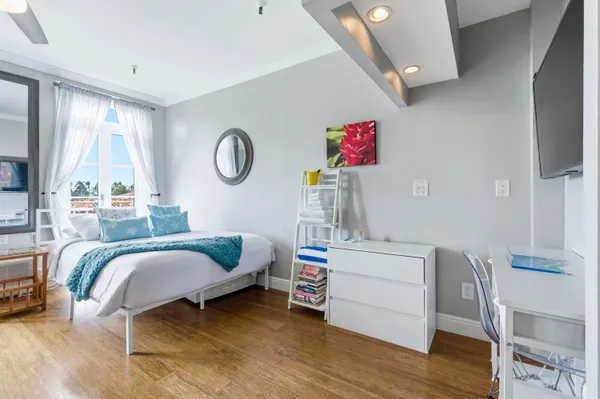 a bedroom with a bed and a chandelier