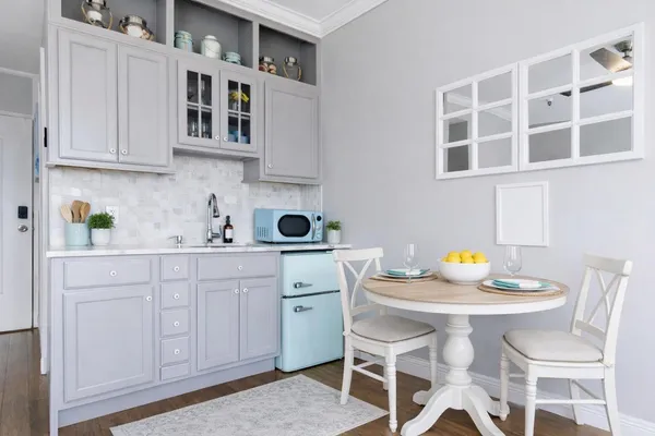a kitchen with stainless steel appliances a sink a table and chairs