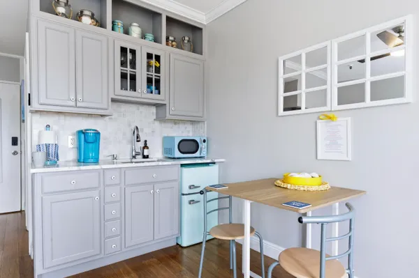 a kitchen with stainless steel appliances cabinets and wooden floor