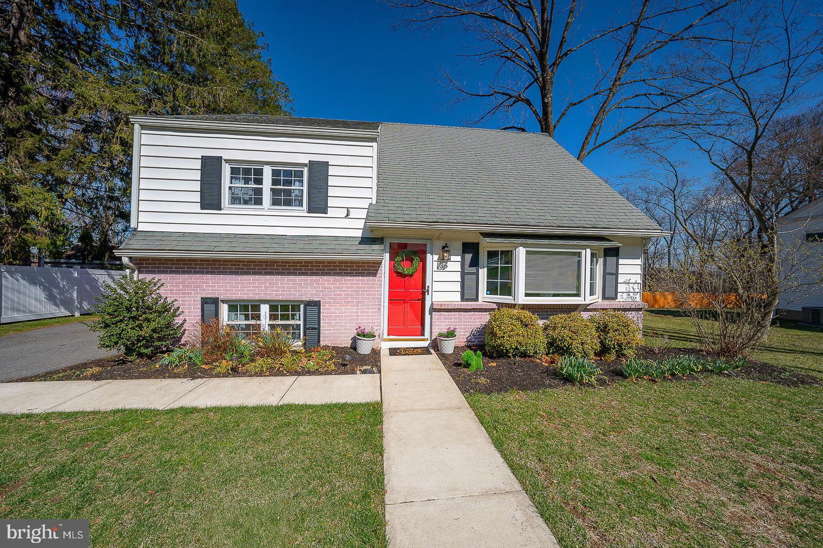 36 Sunset Drive Paoli, PA 19301 - Photo 1 of 69 a front view of a house with a yard and potted plants