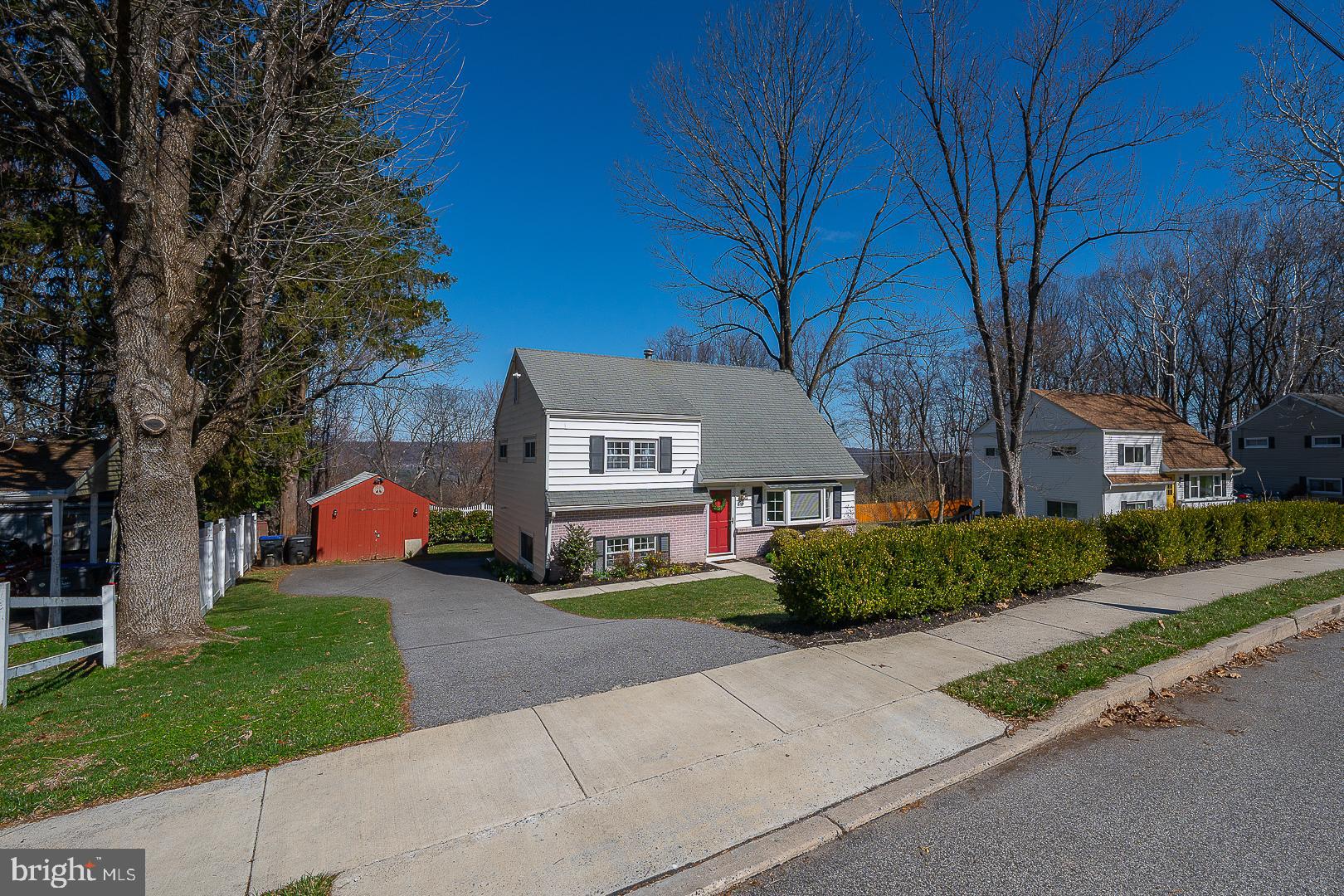 36 Sunset Drive Paoli, PA 19301 - Photo 2 of 69 a front view of a house with a yard and garage