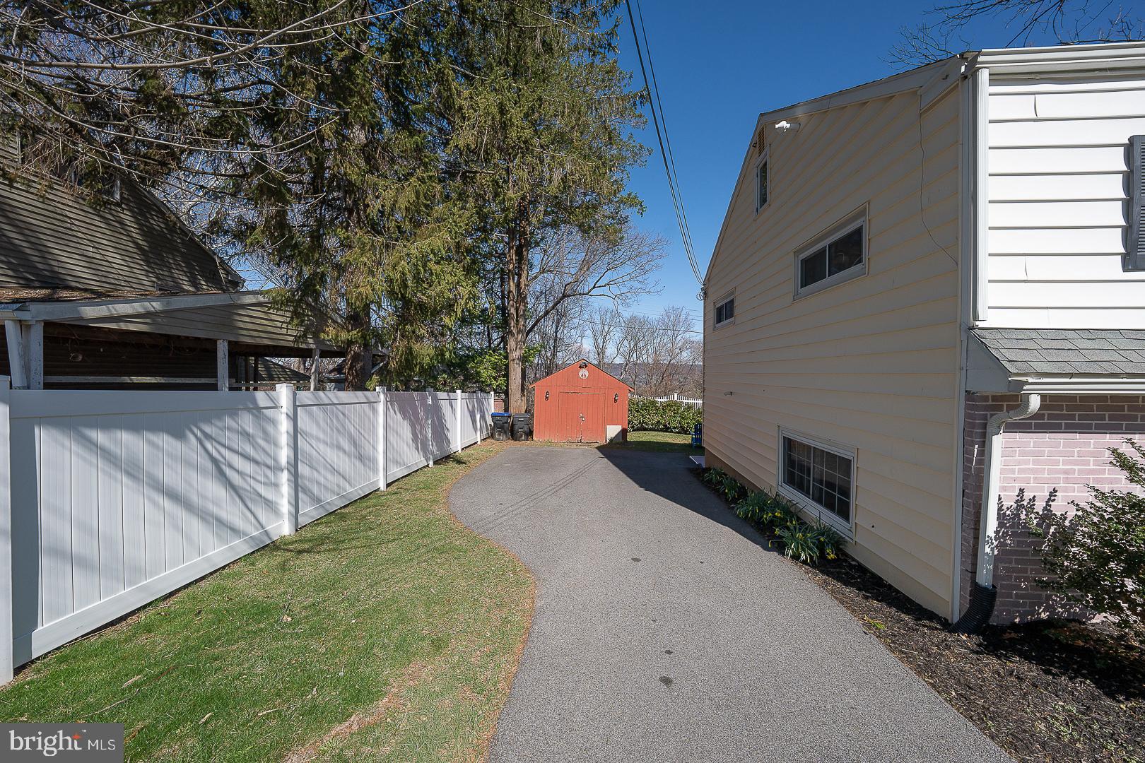 36 Sunset Drive Paoli, PA 19301 - Photo 56 of 69 a backyard of a house with wooden fence and trees